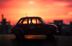 closeup picture of Miniature Car Toy at the sunset