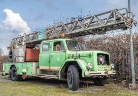 old light green truck with a ladder