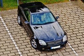 Black Mercedes is standing in the parking lot