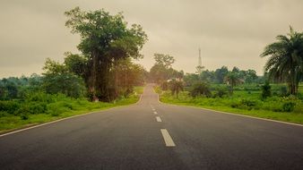 Landscape of rural highway along green fields