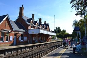 people on a train platform in England