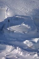 photo of a car under a large layer of snow