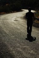 Walking Male Silhouette on Road