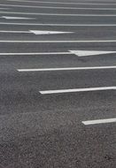 paved road with white arrows close-up