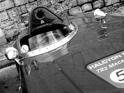 black and white photo of a classic old race car