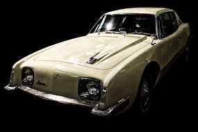 white vintage car on the black background