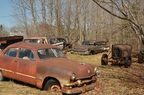 brown rusty cars in landfill