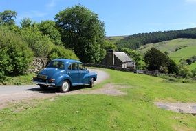 Blue vintage car on a country road