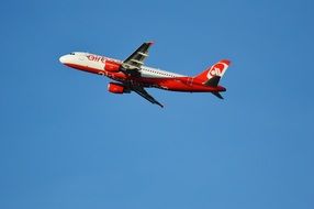 red and grey passenger Aircraft in flight