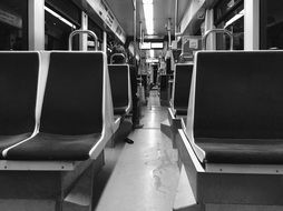 black and white photo of seats on a tram