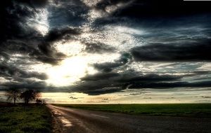 heavy rainy sky over a country road