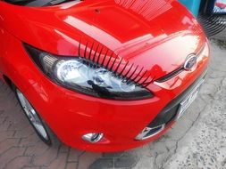 front of the red car