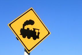 road sign with a black locomotive