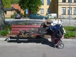 homeless man sleeping on a bench in Stockholm