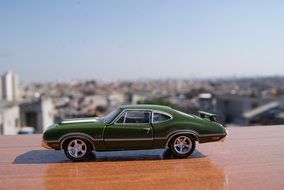 miniature model of green oldsmobile