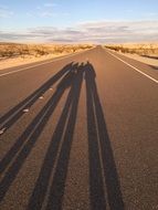 Shadows of people on the road