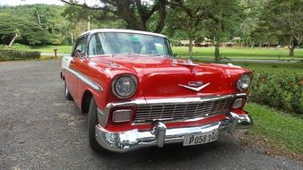 Vintage red car in the park in Cuba