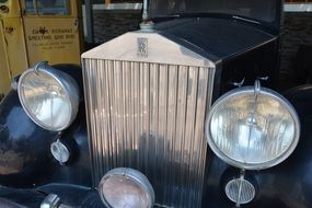 big round headlights of a vintage rolls royce car