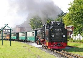 steam train travels along a narrow gauge railway on an island in the Baltic Sea