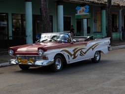 antique car on a city road