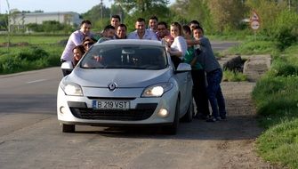 funny group of people around a Renault car