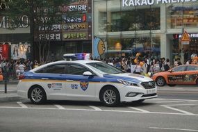 police car on a city street in the republic of korea