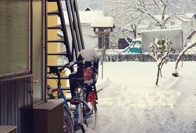 bike in the snow near the house