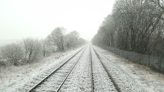 railway tracks covered in snow in December