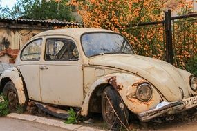 Rusty Volkswagen Beetle is standing on the street