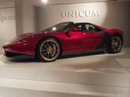 red ferrari as an exhibit in the museum