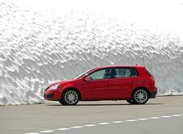 red car in a parking lot near the glacier