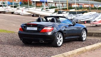 luxury Mercedes-Benz in the parking lot near the lake