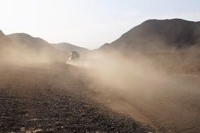 Dust on the road after an all-terrain vehicle ride