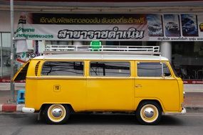 yellow Volkswagen bus on a city street