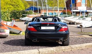 Black Mercedes Benz near the boat station