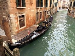 wooden gondola on a canal in Venice, Italy