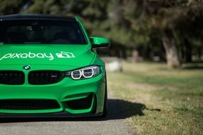 BMW sports green car with the inscription on the hood
