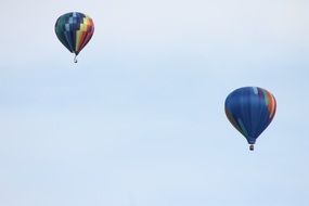 two colorful hot air balloons in the sky