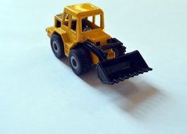 small yellow backhoe loader toy car