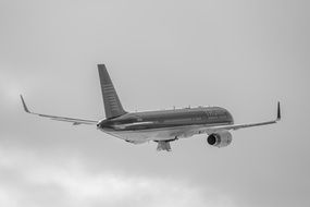 airplane under a cloudy sky