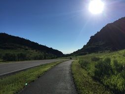 road under the bright sun in colorado