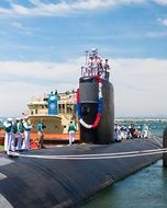 sailors on a submarine on a sunny day
