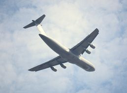 military aircraft in the foggy sky