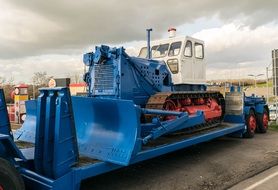 blue construction vehicle with tracks