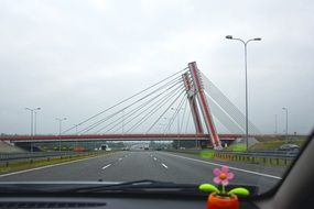 suspension bridge across Highway, view from the car