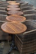 wicker chairs and wooden table in a street cafe bistro