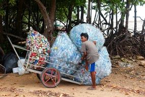 boy collects plastic bottles