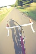 Riding on the bike on the road under the sunshine