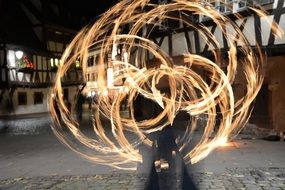 fire circles on the street in the background of the house