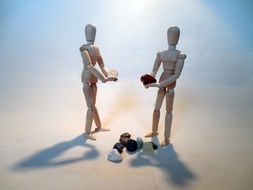 wooden human figures with gems, exchange, concept